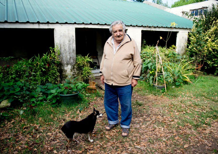 Mujica and his dog in front of his house