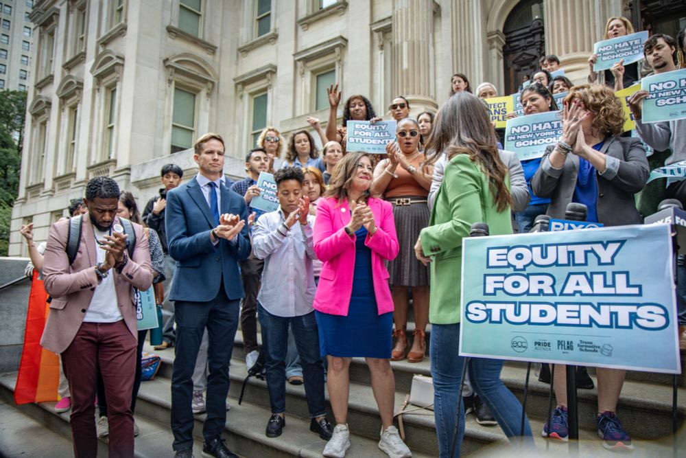 The Public Advocate and elected officials applaud an advocate