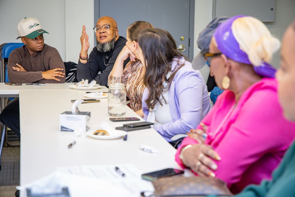 Rev. Yunus Coldman speaks as attendees listen
