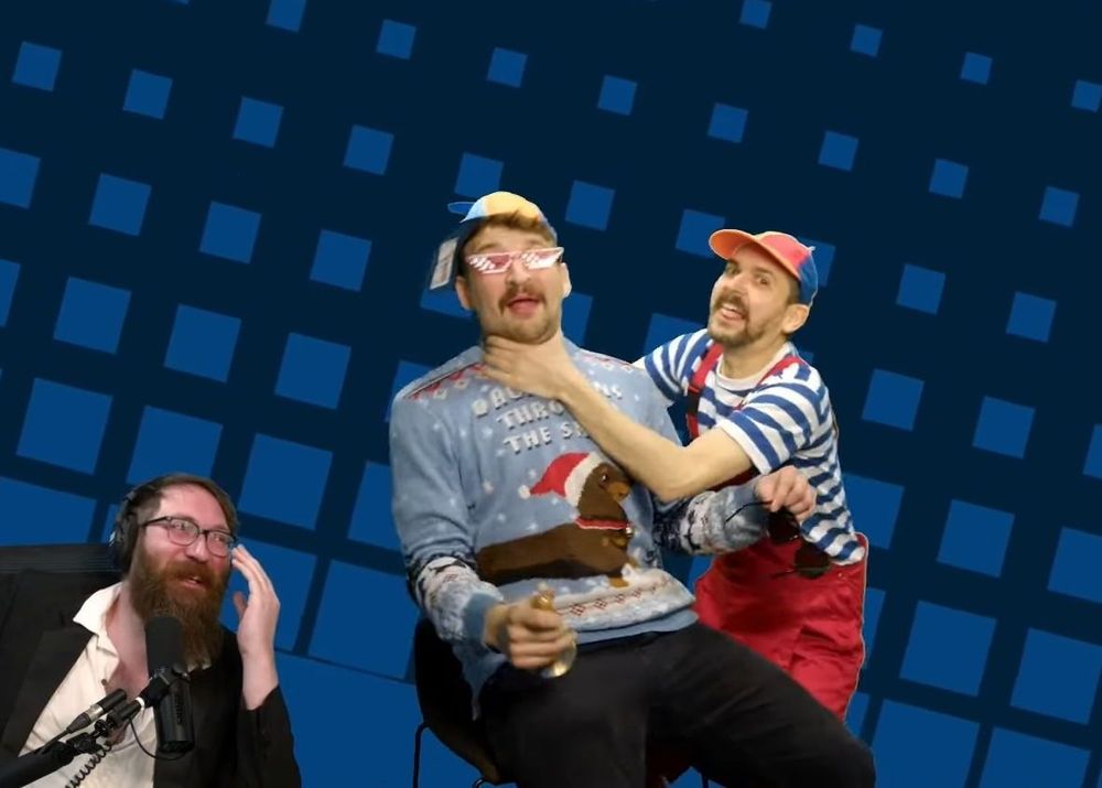 A screenshot from a Yogscast stream. Lewis as Wheel Boy chokes Daf as Bell Dude while Tom looks on, laughing.