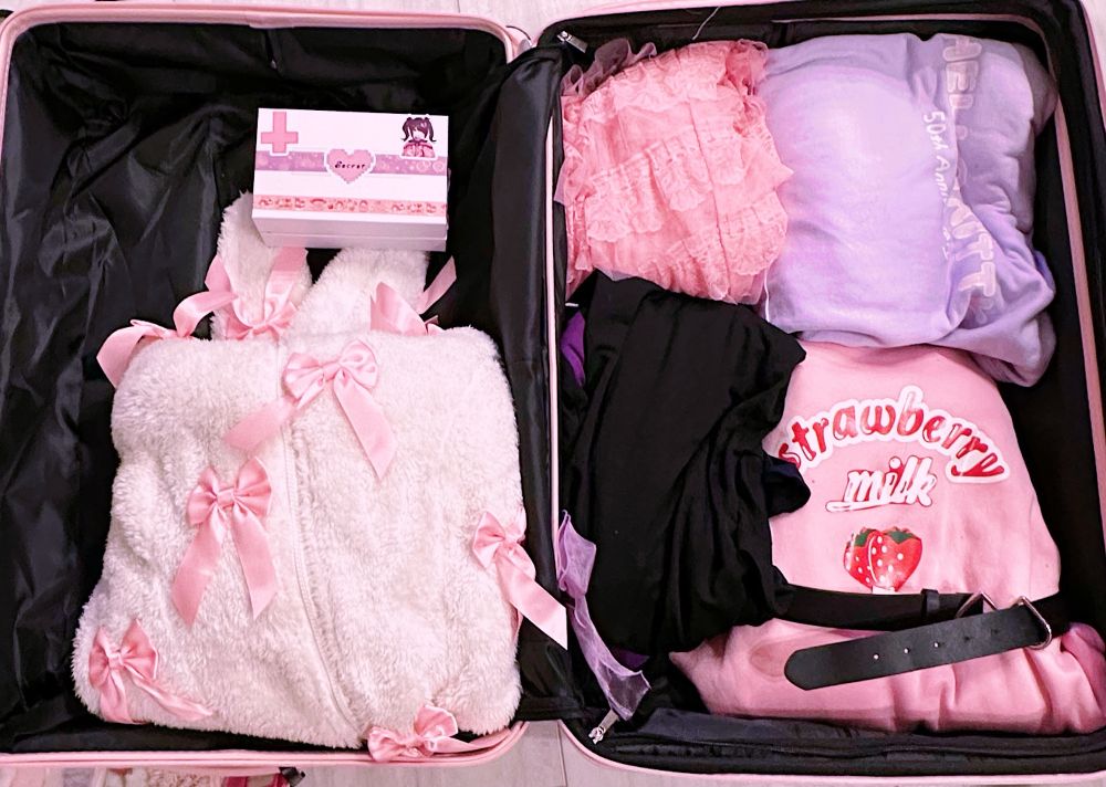 suitcase full of pastel clothes 