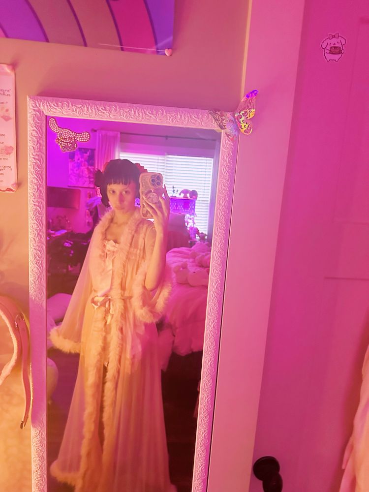 mirror selfie of bunny in a pink house dress