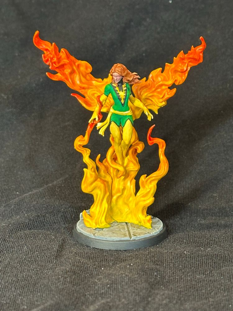 Phoenix model from MCP. A woman in green and yellow rising from a flame, which looks a little like wings