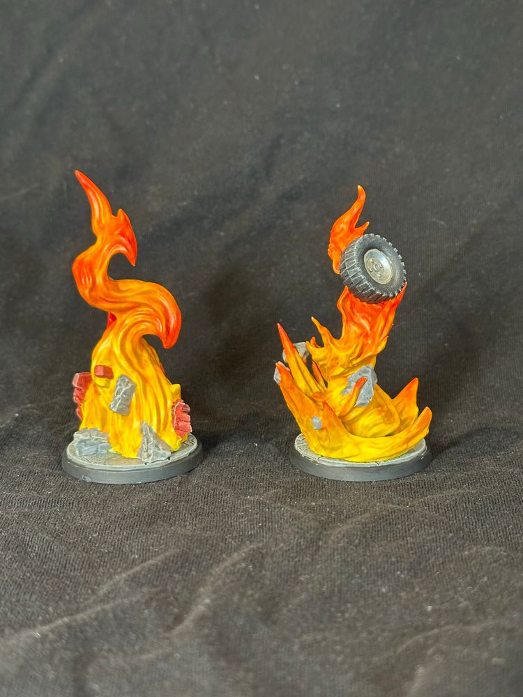 Two models of flaming pillars filled with debris