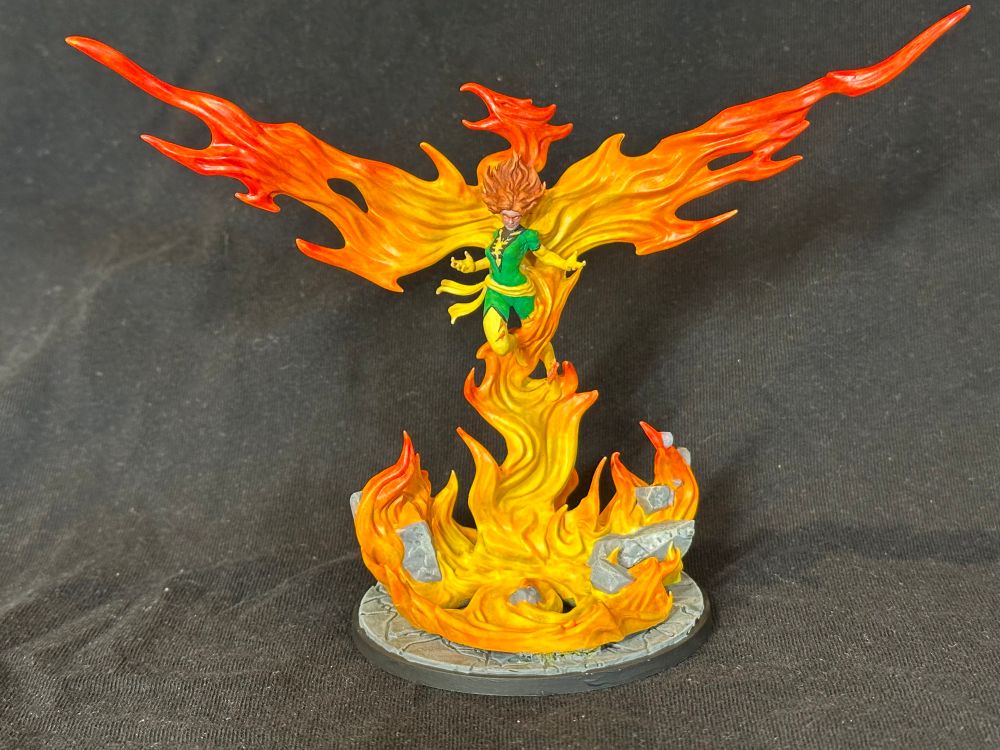 Phoenix Unleashed model from MCP viewed from the front. A woman in green and yellow rising out of a fire in the shape of a bird