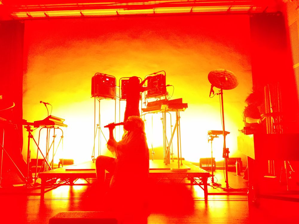Zaho de Sagazan on stage, bathed in orange and yellow light