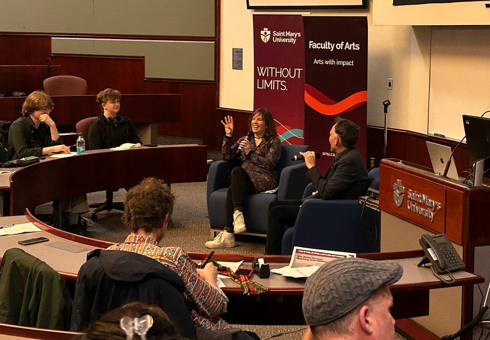 Kate Beaton gesturing as she chats with the audience at Saint Mary's, during the 2025 Cyril J. Byrne Memorial Lecture. 