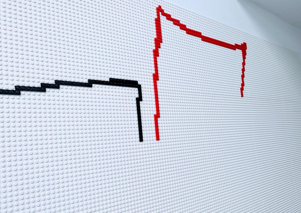 Photograph of black and red Lego on the wall in the Digital Den