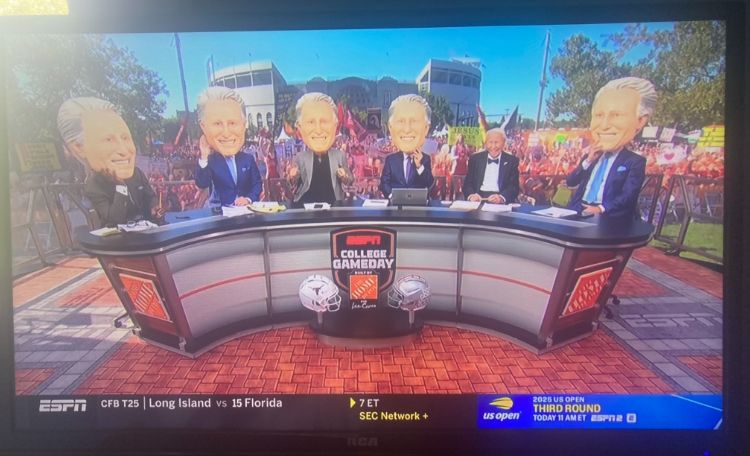 everyone wearing giant lee corso heads. the real lee corso also there, looking pleased