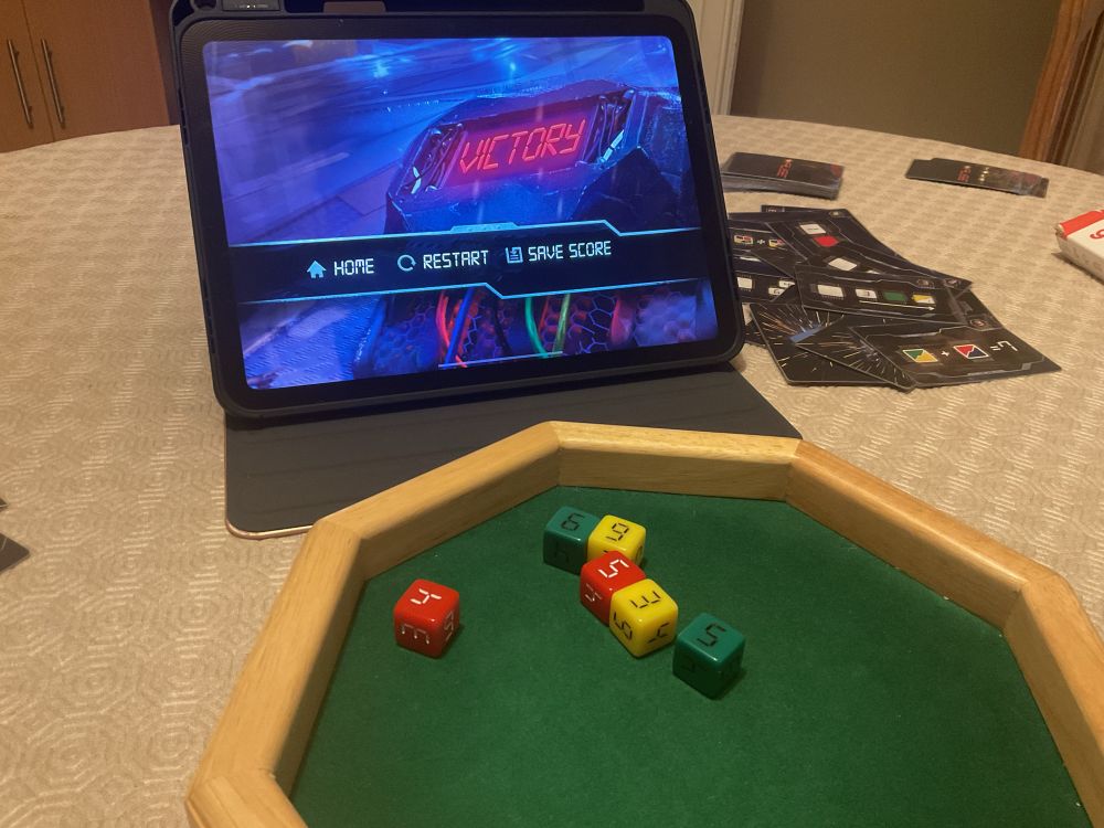 The photo shows the Fuse app on a tablet and some random coloured dice on a green dice plate.