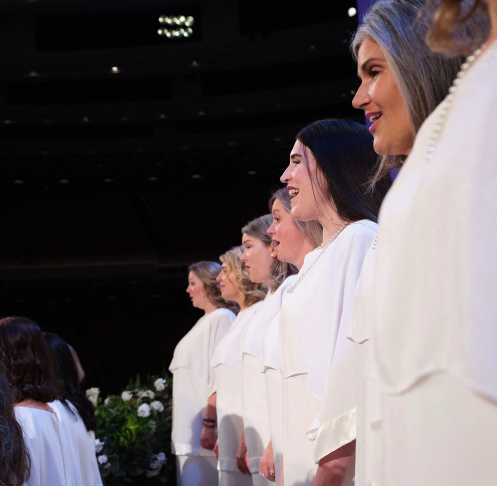 The performers from the first image, seen from the side. The cropped top portions of the outfits are all hanging at different heights and angles on different body types. 