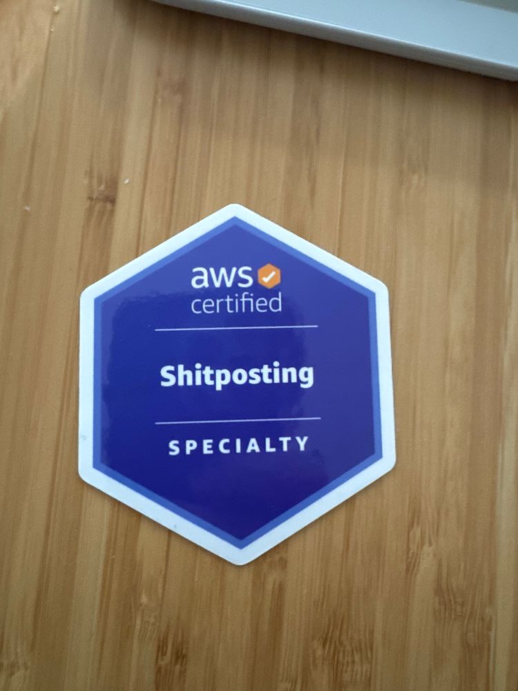 A laptop sticker for an AWS specialty certification in shitposting