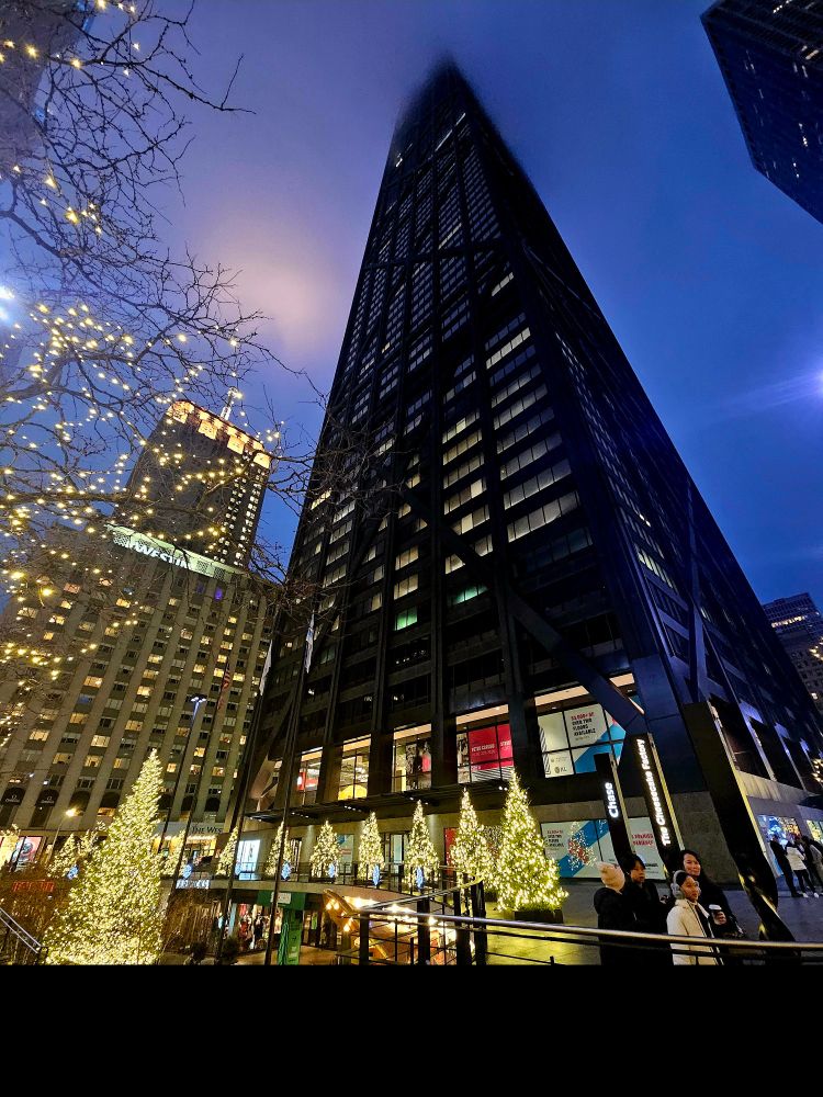 The view looking up as 875 North Michigan Avenue disappears into a dense Chicago fog.