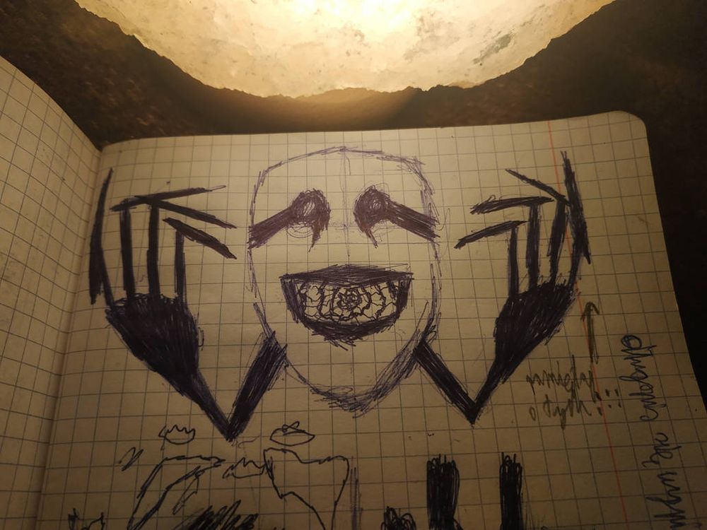 A giant scary mask in the middle, big black scary hands are coming out of it's back, something you can't really understand under it, a big white sun is burning my eyes above it