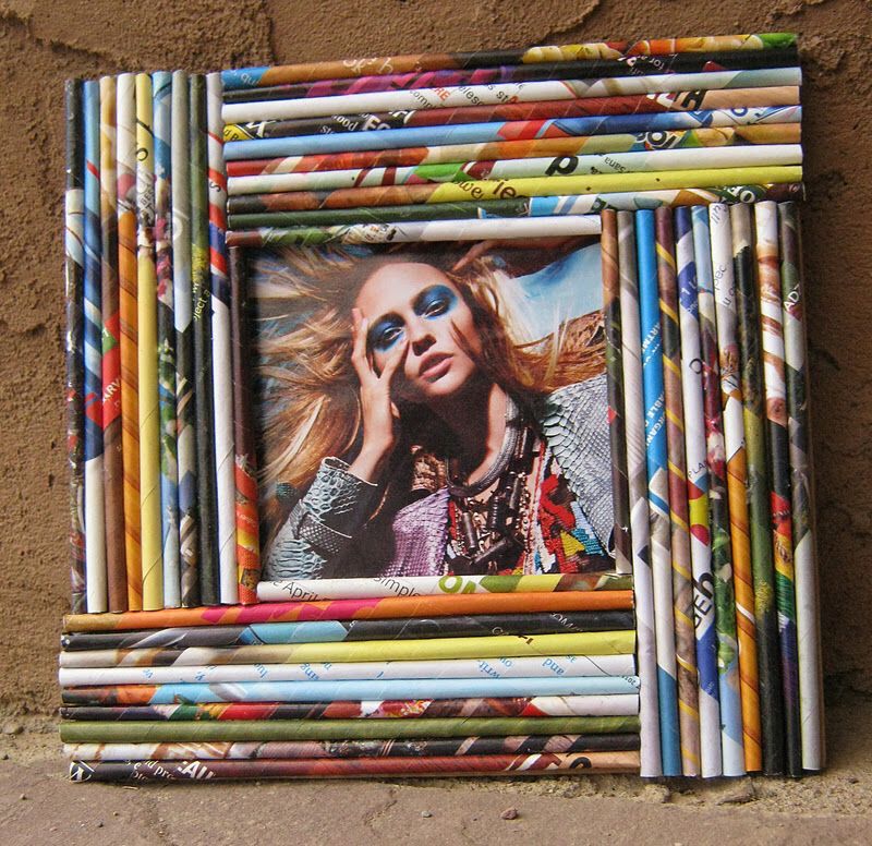 Colorful picture frame made out of rolled-up magazine pages, arranged horizontally and vertically around a photo in the center.