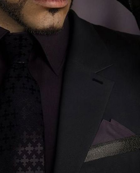 Rude's tie in FFVII Remake, with the pointed trefoil cross pattern clearly visible.