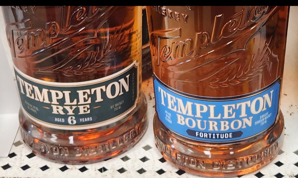 Two bottles of alcohol that says "Templeton rye" and "Templeton bourbon." 