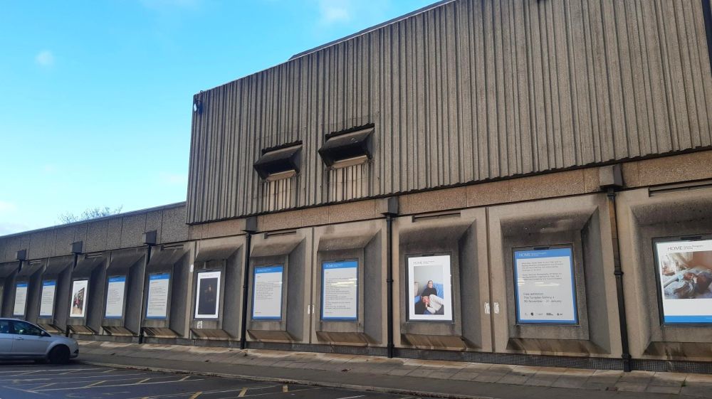 Exterior of Turnpike Centre building with photographs and poems in the windows