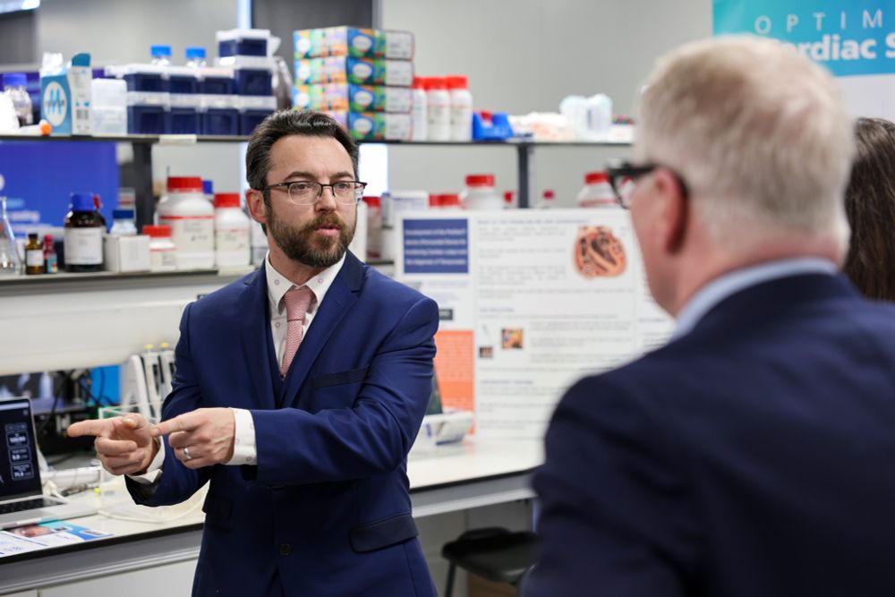 A person pointing while talking to another person.