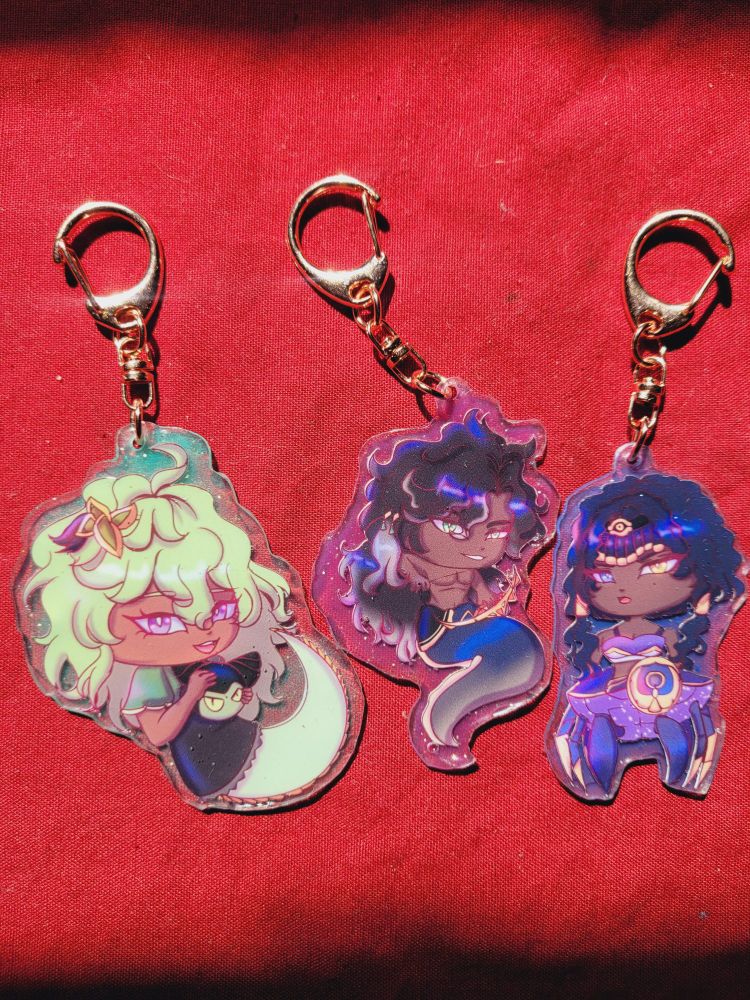 A keychain of collei, Sethos, and Candace from Genshin Impact 