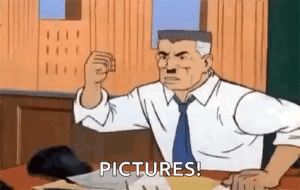 a cartoon man is sitting at a desk with his fist in the air and says pictures .