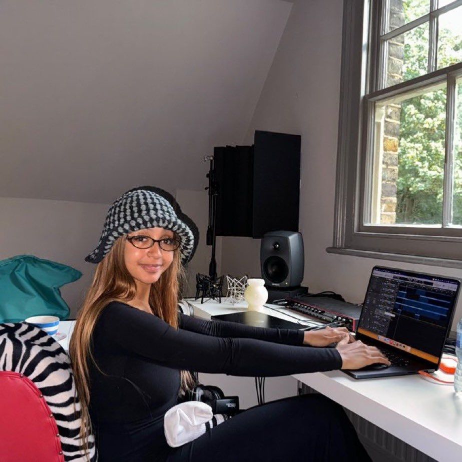 pinkpanthers wearing a gay little hat, smiling at the camera while typing away in logic pro x