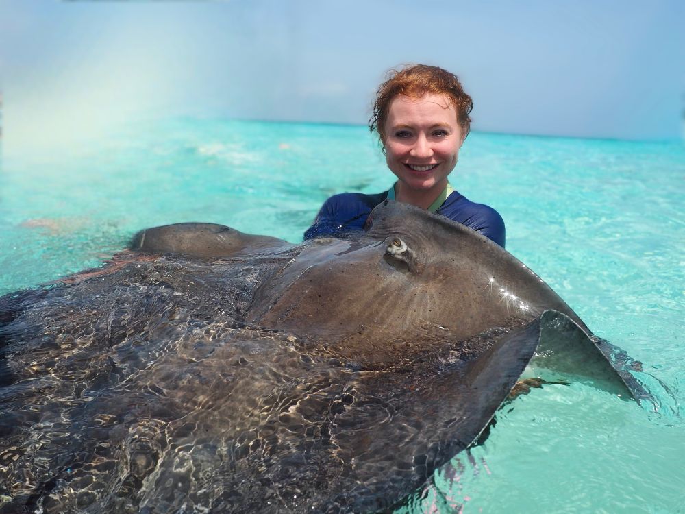 Me with a stingray in the Cayman Islands sea 