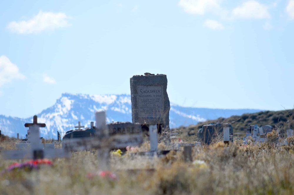 Sacagawea’s gravestone, with a mountain in the distance.