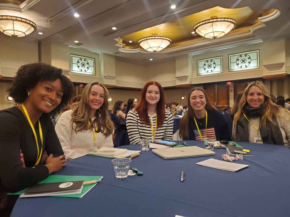 Students at table in hotel ballroom preparing for STR training