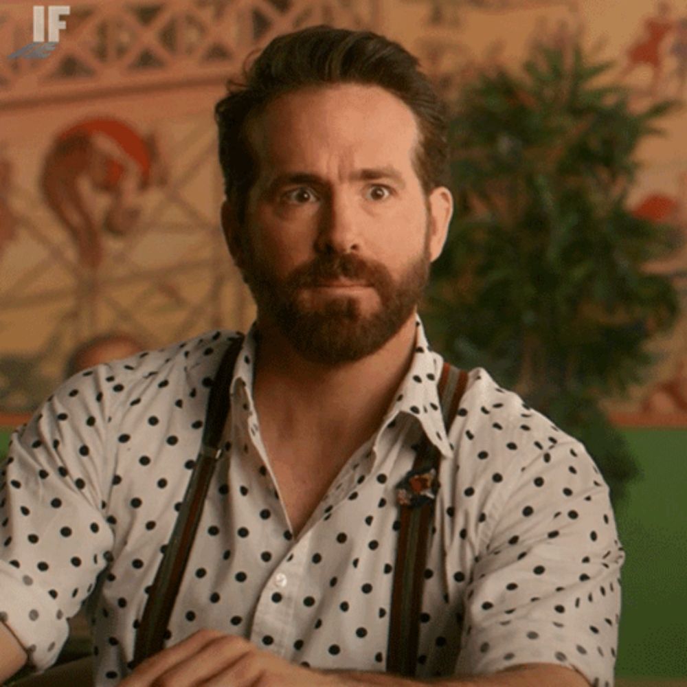 a man with a beard is wearing a polka dot shirt with suspenders