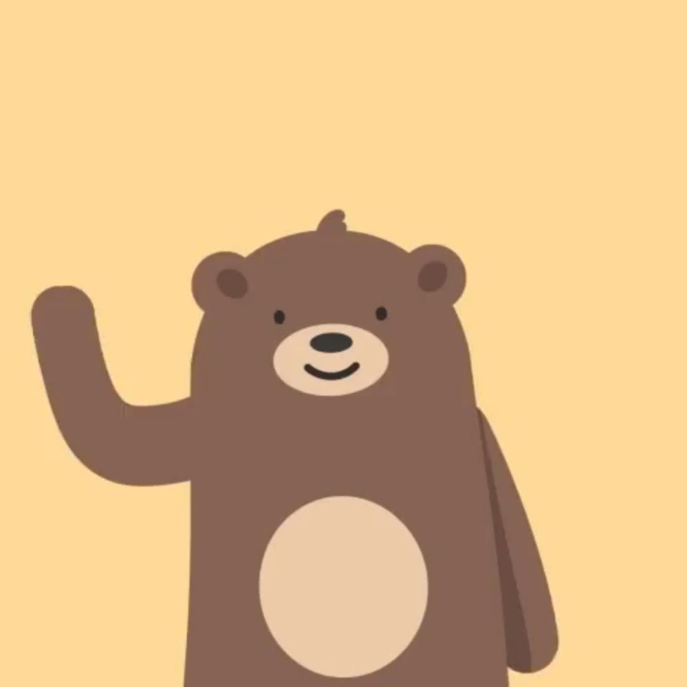 a brown teddy bear is waving his arm and smiling