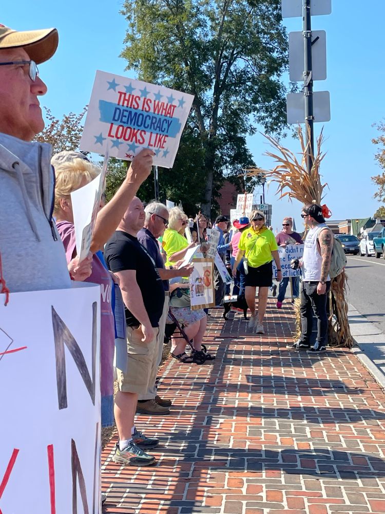 Protesters holding anti-Trump signs.