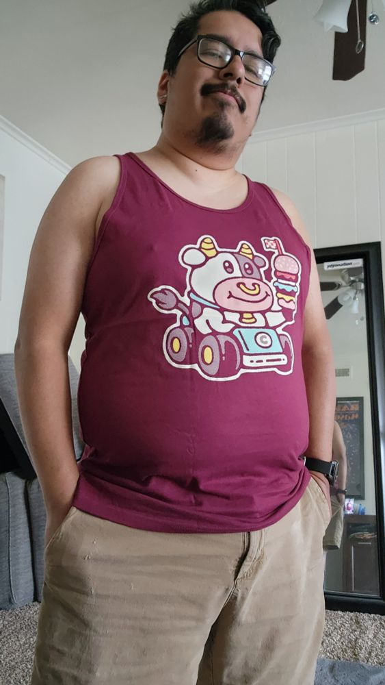 A silly potato showing off his new tank top, which features the cow from Mario Kart World delivering a burger! 