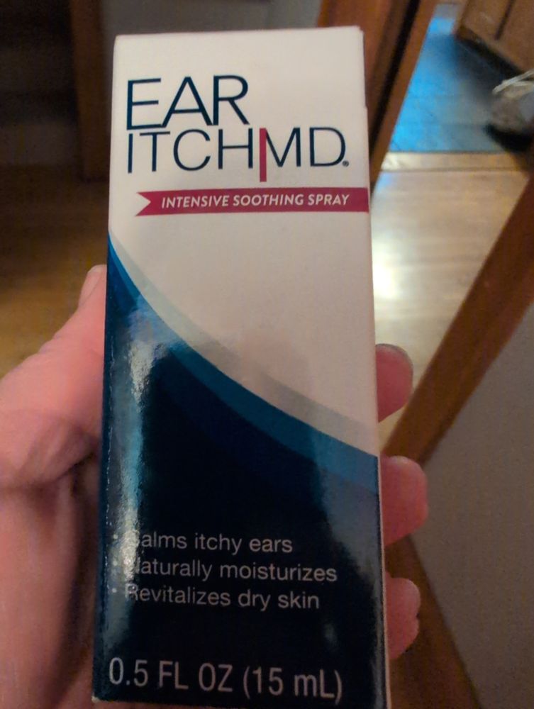A have holding a box labeled ear itch md
