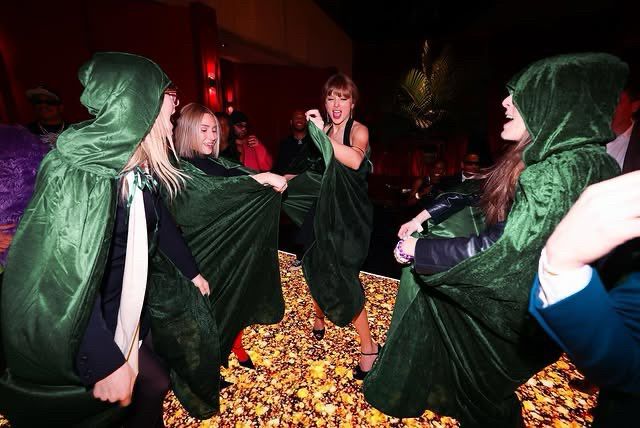 taylor with friends in green willow capes