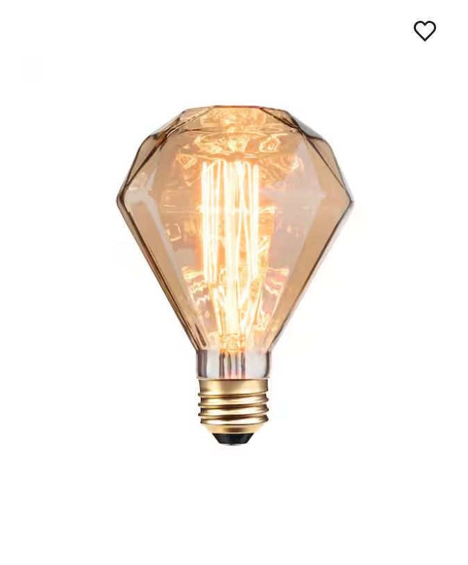 A lightbulb that's gem shaped, with exposed vertical filament in amber glass, making it look like gold tinsel inside. 