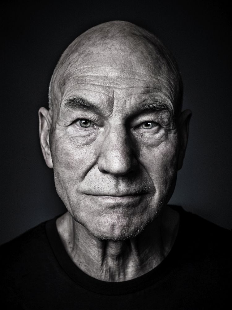 A portrait photo of English actor Sir Patrick Stewart. He gained international stardom for his leading role as Captain Jean-Luc Picard in "Star Trek: The Next Generation" (1987–1994), a role he reprised in a series of films and "Star Trek: Picard" (2020–2023).