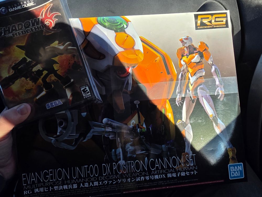 Photo of shadow the hedgehog for gamecube and a real grade eva00 model kit.