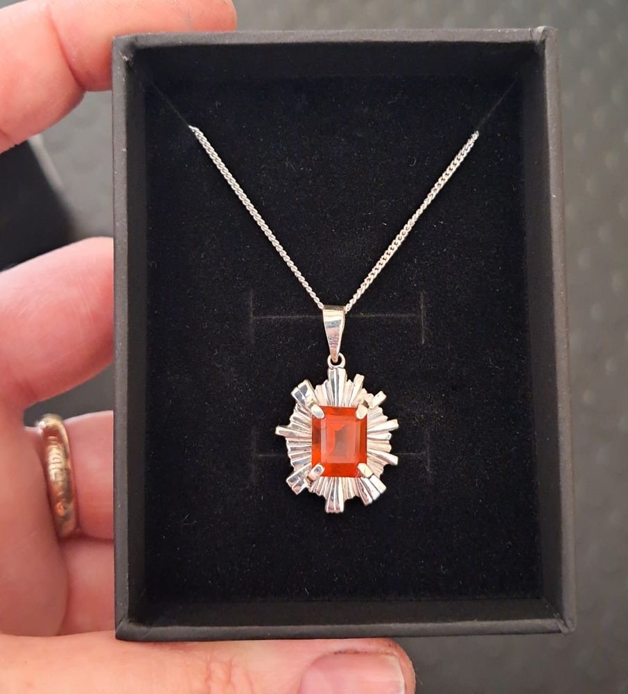 A fire opal set in a necklace.