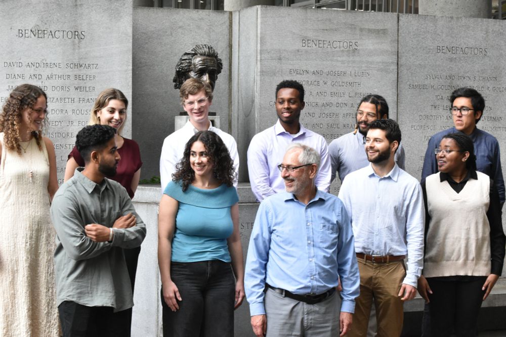 New Medical Scientist Training Program students gather in front of bust of Albert Einstein at the Forchheimer Medical Science Building to take their group photo with program leader Myles Akabas.