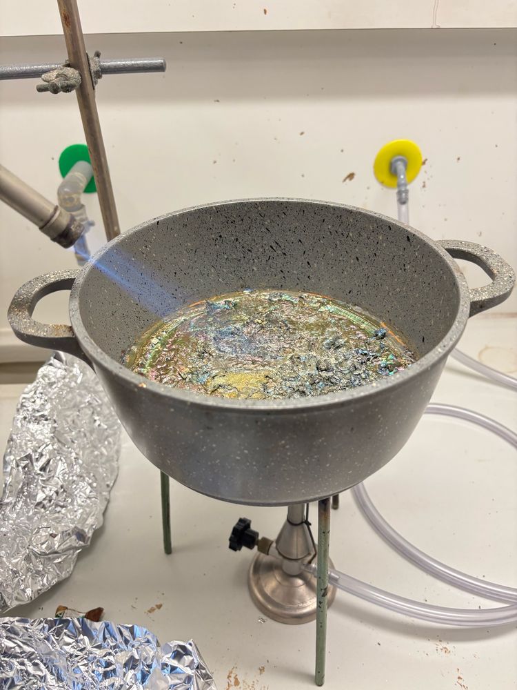 Liquid bismuth with a visible oxide layer on top.