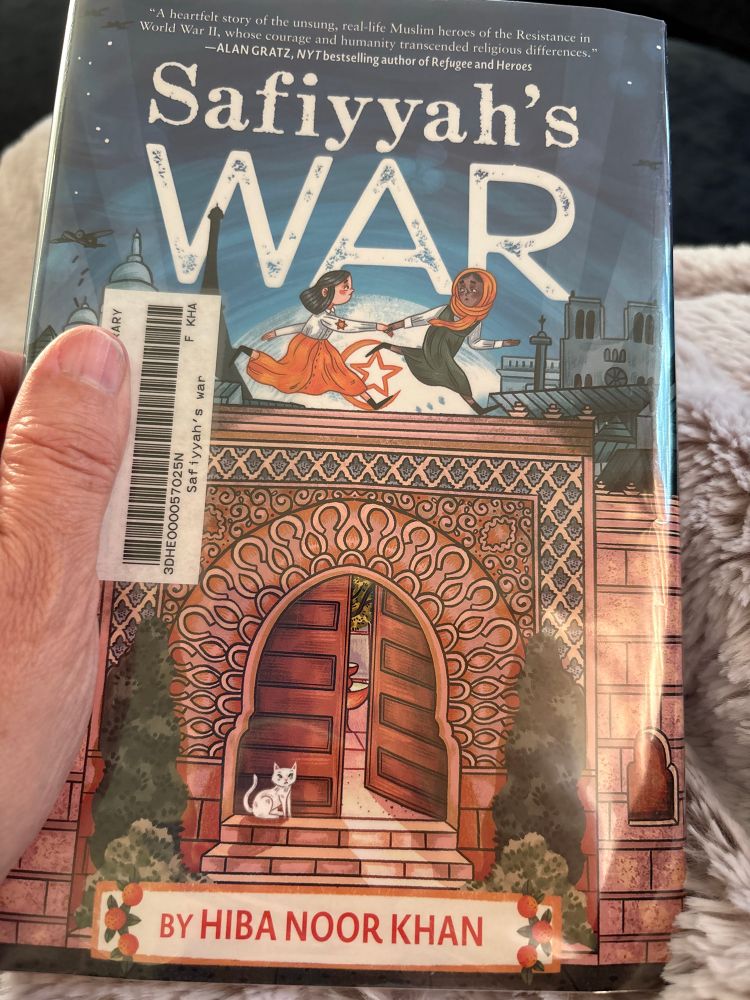 Book cover Safiyyah’s War by Hiba Noor Khan 
    Picture of a Mosque doorway with a brown skin girl with orange head scarf leading a white skin girl with dark hair and an orange star on her sleeve as they run across the cover.