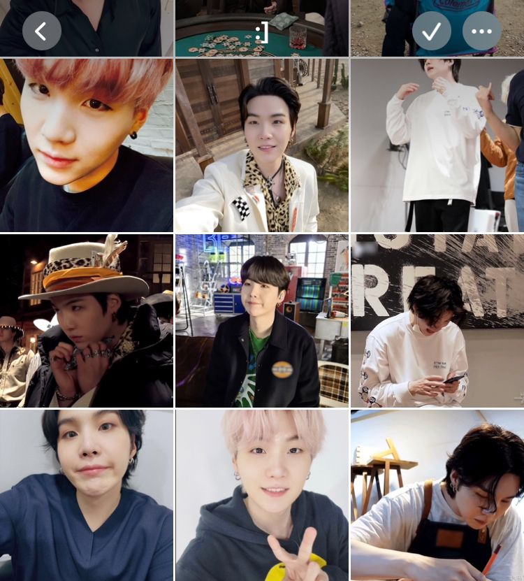 A grid of photos of BTS member Yoongi looking cute and adorable and sweet and perfect, specifically: a selca with light red hair where he’s giving the camera a sweet almost-smile; a selca from behind the scenes of the That That music video where his dark hair is swept back from his forehead and he’s half-smiling with his lil’ teeth out; a behind-the-scenes photo of him practicing dancing with a bare face and very fluffy dark hair; a gif of him behind the scenes of the That That music video shoot in which he’s wearing a very fancy hat and lots of heavy silver rings but he’s got a winter coat draped over his shoulders and he’s snuggled into it, holding a hand warmer under his chin with both hands and making an expression that’s almost a pout; a picture of him going :] from behind the scenes of the band’s MTV performance of songs from BE; a gif of him looking at his phone, hair long and dark and fluffy, and then looking up with an adorable excited smile on his face; a closeup selca of him going :] with his hair long but off his forehead, really leaning into the expression so his chin kind of crinkles and his cheeks are super cute and round; a selca of him giving a small cute smile and a V sign with his hand, wearing a grey hoodie with light pink hair; a gif of him making an intensely endearing face of concentration as he works on drawing an outline of something on the table in front of him, wearing an apron and with one strand of dark hair falling over his face
