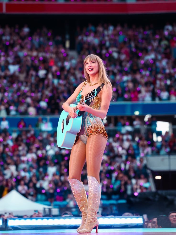 Taylor swift smiling during an eras tour show 