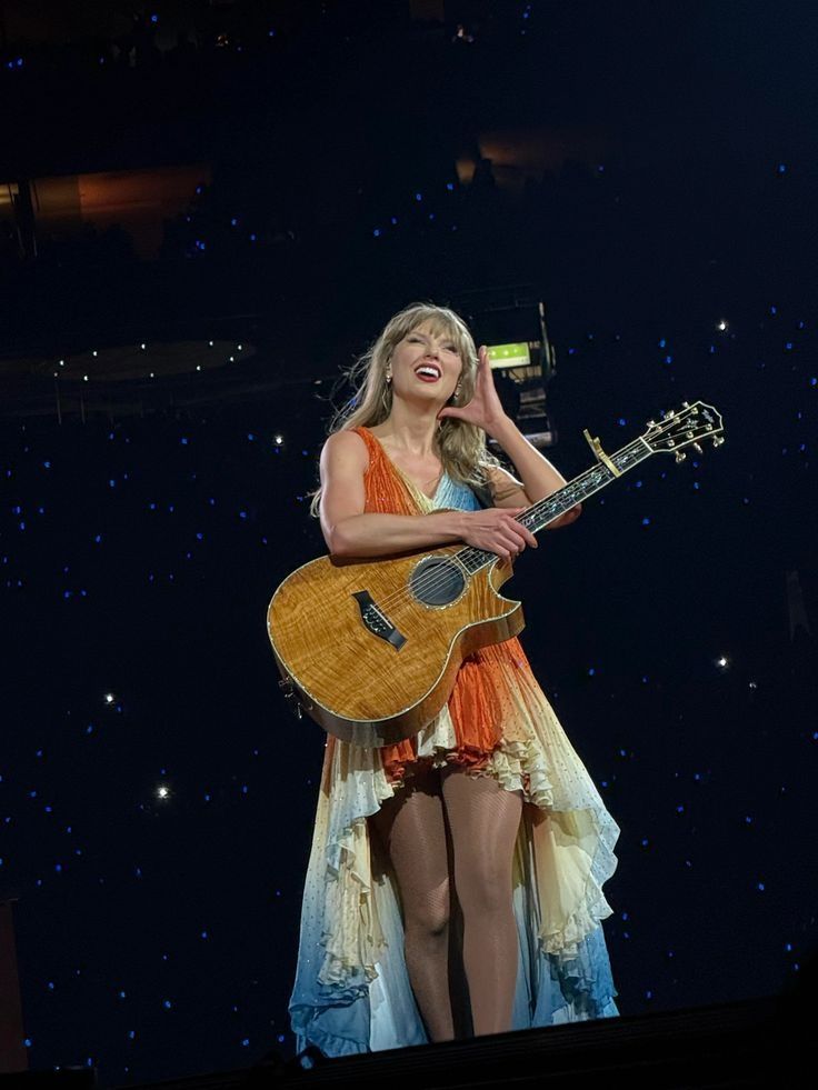 Taylor swift smiling during an eras tour show 