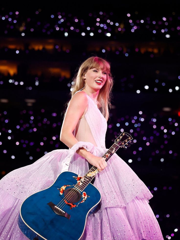 Taylor swift smiling during an eras tour show 