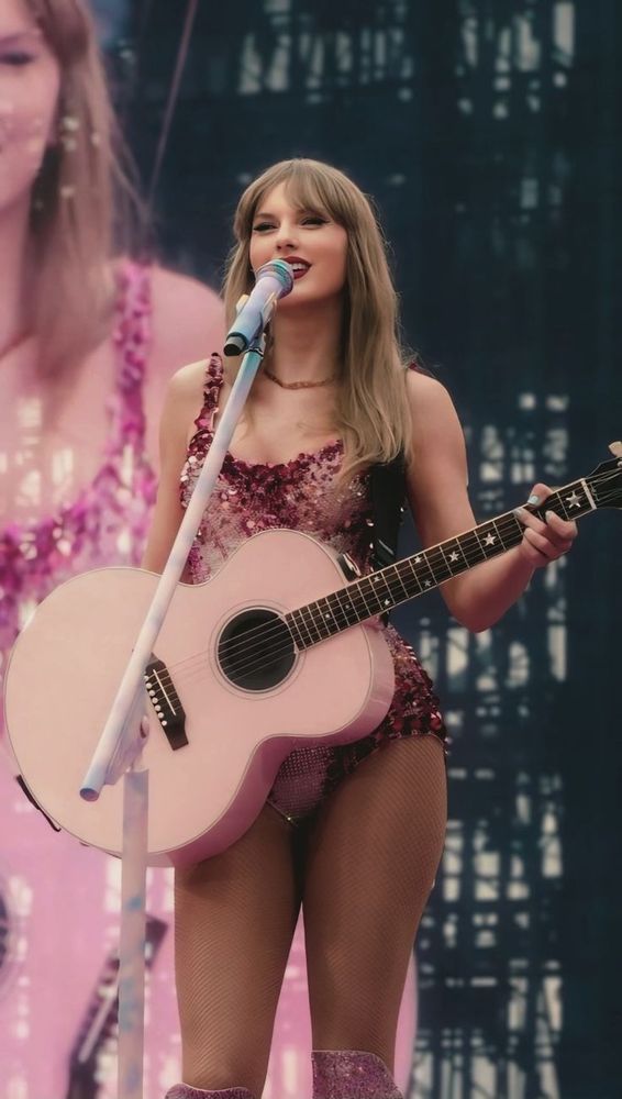 Taylor swift smiling during an eras tour show 