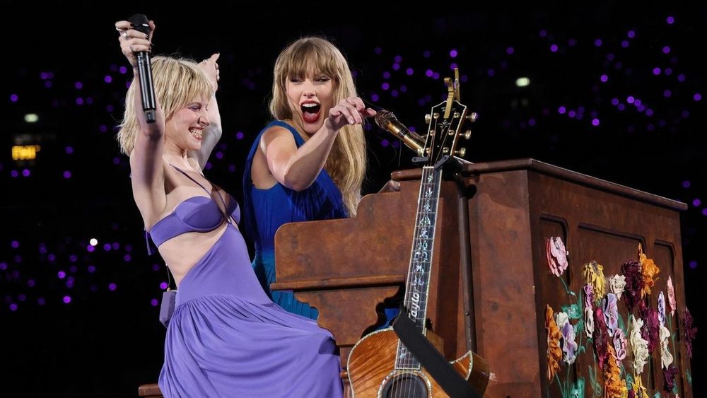 Taylor swift and Hayley Williams at the piano performing castles crumbling during an eras tour show