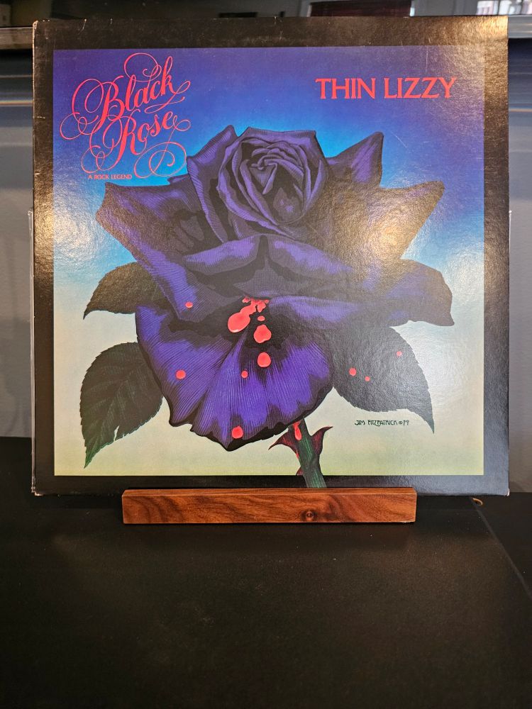 The front cover for Black Rose (A Rock Legend) by Thin Lizzy. An artistic rendition of a black rose.