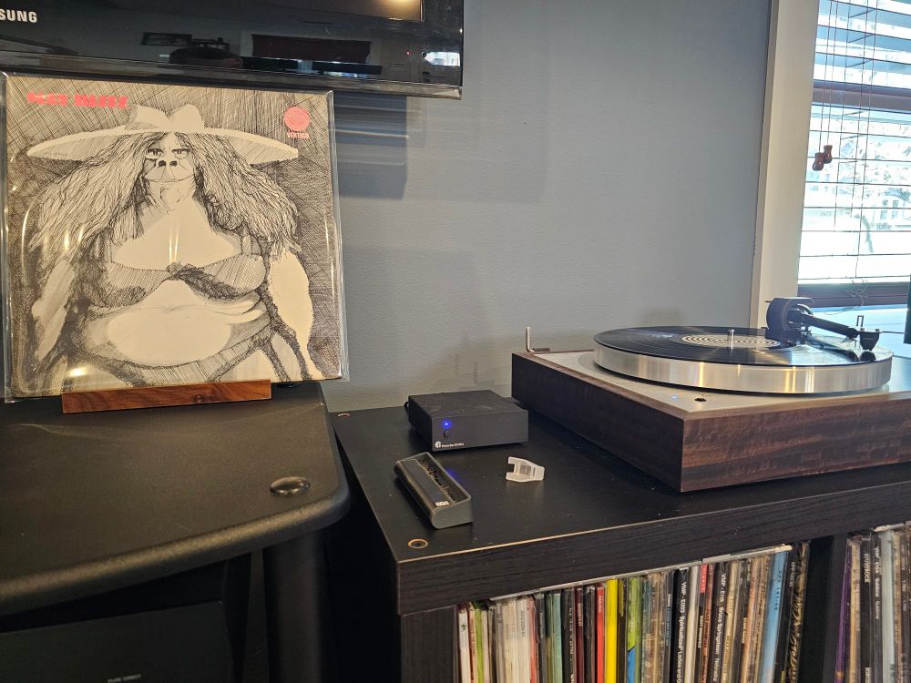 May Blitz first album next to a turntable playing the record.